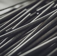 a bunch of metal rods with a black and white background