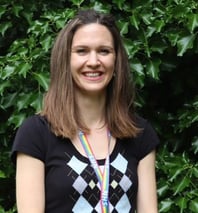 a female dementia coach wearing a black shirt and a colourful necklace