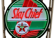 a sky chief neon sign with a sky chief,sky chief sign,sign,texaco sign,