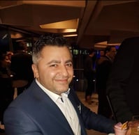a man in a suit and tie smiling for a picture