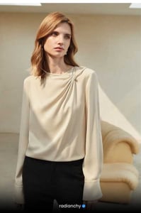 a woman in a white blouse and black pants