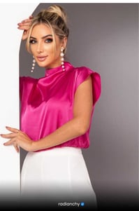 a woman in a pink top and white pants