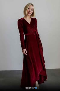 a woman in a red dress with a long sleeved dress
