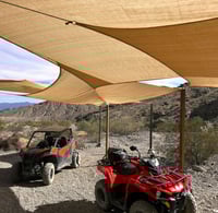 two atvs parked in a desert area