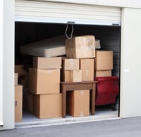 a garage door is open to reveal a lot of boxes of boxes
