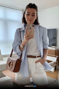 a woman in white pantsuits and a blue shirt