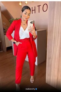 a woman in a red suit and white shirt