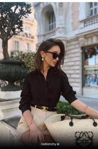 a woman in a black shirt and white shorts
