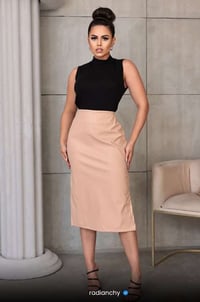 a woman in a black top and skirt with a black top