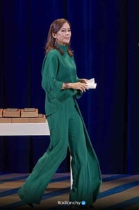 a woman in a green dress and a man in a suit