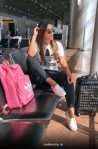 a woman sitting on a bench in an airport