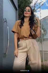 a woman in a tan top and tan pants