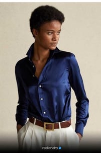 a woman in a blue shirt and white pants