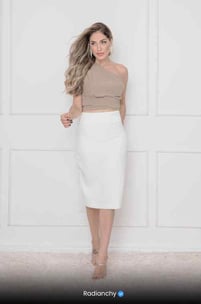 a woman in a white skirt and crop top