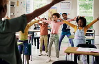 Students doing physical movement in the classroom.