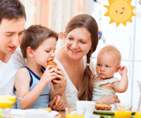 a family sitting at a table with a baby and a boy eating a sandwich