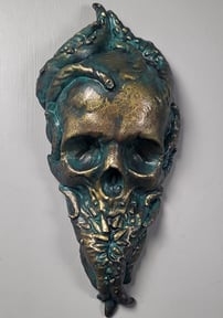 Bronze Cthulhu plaque. A skull with tentacles growing out of it. Teeth grow out of the tentacles to form the bottom jaw.