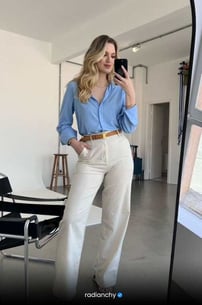 a woman in a blue shirt and white pants