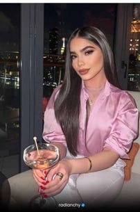 a woman in a pink shirt and white pants