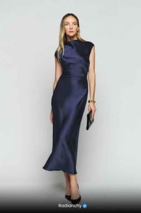 a woman in a blue dress with a clutch bag