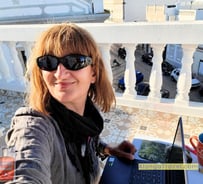 Alonga Travel the author works on her laptop from a rooftop terrace in Portugal