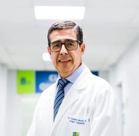 Doctor en un hospital con una bata blanca sonriendo