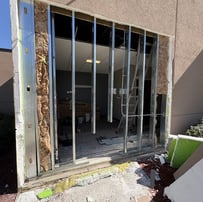 exposed studds and stucco after fixing damaged building frame