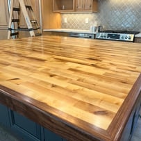 Handcrafted wood and epoxy butcher block countertop with a durable, smooth finish, blending natural wood grain with modern de