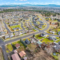 Professional photograph of an aerial view of some houses.