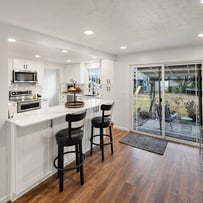 Professional photograph of a new kitchen design with a sliding door for outside.