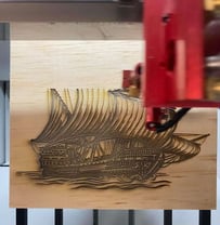 a machine that is cutting through a piece of wood