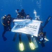 underwater group photo with flag