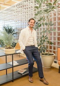 Fertility clinic specialist welcoming patients in a modern lounge area.