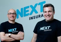 next insurance two men standing next to each other in front of a next - to - sign