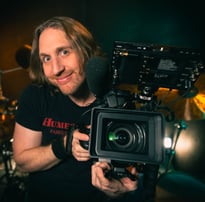 a man holding a camera and recording a video camera