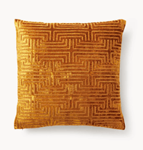 a gold coloured cushioned pillow with a maze pattern