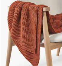 a chair with a blanket on it 