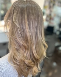 a woman with blonde hair beautiful balayage