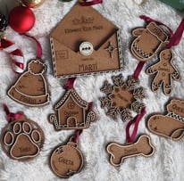 a bunch of personalized wood christmas ornaments and decorations on a white blanket