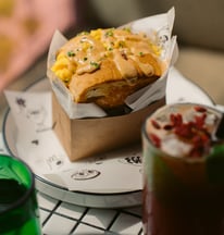 a table with a bowl of soup and a sandwich