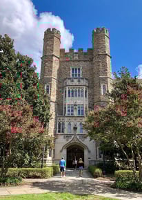 a man and woman walking in front of a building