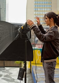 Youth setting up a video light