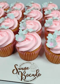 a bunch of cupcakes with pink frosting