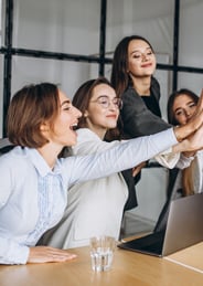 a group of business people giving high five fingers up