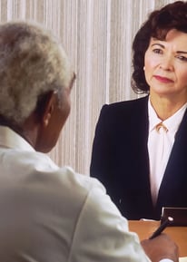 man in black suit jacket standing beside woman in white dress shirt