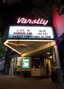 a theater marquee with a sign that says alice in wonderland