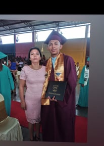 Angel, as scholarship student poses with his mother, Yelba at his high school graduation