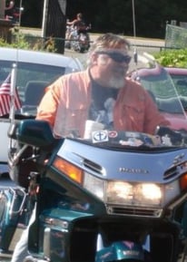 Happy biker riding motorcycle.