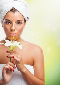 a woman wrapped in a towel with a flower