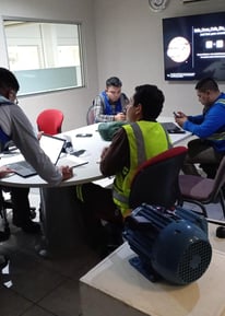a group of people sitting around a table
